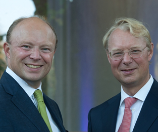two European guys are smiling together.